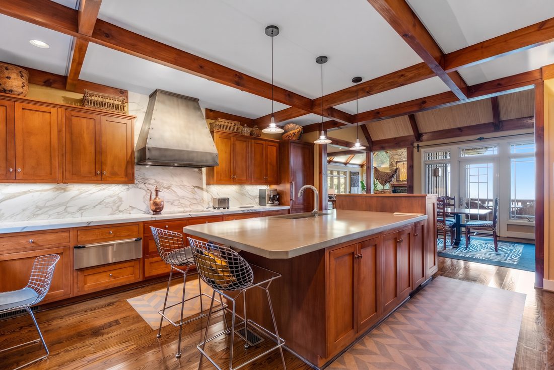 Kitchen, concrete island and hammered-metal hood